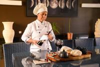 een chef-kok in een keuken die eten bereidt bij Casa Pouso das Fadas com Arrumadeira e Cozinheira Profissional in Maragogi