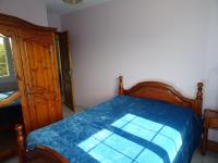 a bedroom with a bed with a blue blanket on it at Maison Les Sables-d&#39;Olonne, 4 pièces, 6 personnes - FR-1-92-798 in Les Sables-d&#39;Olonne