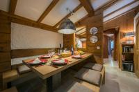 a kitchen with a wooden table and a dining room at Résidence Améthystes A14 ski-in ski-out - Happy Rentals in Chamonix