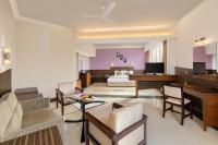 sala de estar con cama y escritorio en Sangam Hotel, Thanjavur, en Thanjāvūr