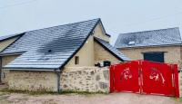 a house with solar panels on top of it at Gite du Moulin in Saint-Laurent-dʼAndenay