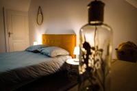 a bedroom with a bed and a bottle on a table at Le Nid • Cocoon • Netflix • Proche Centre-Ville in Châteauroux