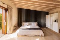 a bedroom with a large bed with black curtains at Hotel Rural Xereca in Puig D’en Valls