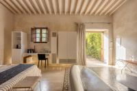 a bedroom with a bed and a desk in a room at Hotel Rural Xereca in Puig D’en Valls
