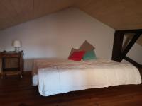 a bedroom with a bed with two pillows on it at Gîte Les trois charmes in Gouvy