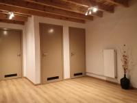 an empty room with two doors and a vase at Gîte Les trois charmes in Gouvy