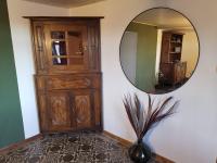 a mirror in a room with a dresser and a vase at Gîte Les trois charmes in Gouvy