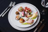 um prato branco de comida numa mesa com talheres de prata em Hotel Oxford By TimHotels em Timişoara