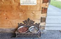 a metal bowl of food on a table next to a wooden wall at Lovely Home In Dalaas With Kitchen in Dalaas