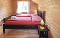 a bedroom with a bed in a wooden cabin at Lovely Home In Dalaas With Kitchen in Dalaas