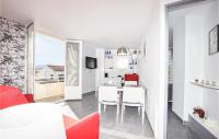 a kitchen and living room with a table and chairs at Amazing Apartment In Saint Cyprien Plage With Wifi in Saint-Cyprien-Plage