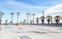 a large plaza with palm trees and a blue sky at Amazing Apartment In Saint Cyprien Plage With Wifi in Saint-Cyprien-Plage