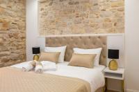 Posteľ alebo postele v izbe v ubytovaní Le Premier Luxury Rooms