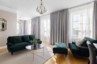 a living room with green furniture and a chandelier at Best Western Motala Stadshotell in Motala