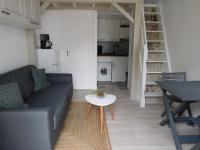 a living room with a couch and a table at Maison La Faute-sur-Mer, 2 pièces, 4 personnes - FR-1-476-184 in La Faute-sur-Mer
