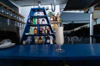 a drink sitting on a blue counter in a bar at EDMA APARTAHOTEL in Santa Bárbara de Samaná