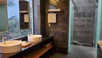 a bathroom with two sinks and a large window at Fu Wan Cafe Villa in Donggang