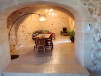 a dining room with a table and chairs in an archway at Ta’ Peppi Farmhouse in Qala