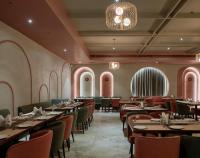 Un restaurante con mesas y sillas y una lámpara de araña. en Hotel Akruti, Nanded, en Nanded