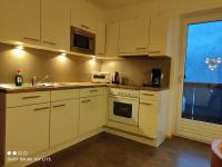 a kitchen with white cabinets and a sink and a window at groassehof Haus Gstrein in Imsterberg