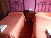 A bed or beds in a room at Hostal Venta Liara