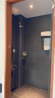 a bathroom with a shower with a glass door at Fu Wan Cafe Villa in Donggang