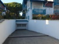 an empty parking lot in front of a white building at Apartment Les Berges Landaises-1 by Interhome in Soorts-Hossegor