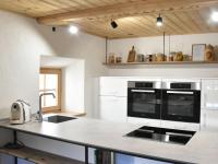 a kitchen with white cabinets and a counter top at Apartment Appartment Wiesberg by Interhome in Niedernsill