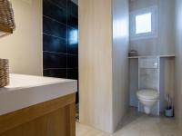 a bathroom with a toilet and a sink at Holiday Home La Plage by Interhome in Denneville