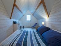 a bedroom with a bed and a desk in a room at Holiday Home La Plage by Interhome in Denneville