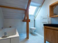 a bathroom with a sink and a toilet and a window at Holiday Home La Plage by Interhome in Denneville