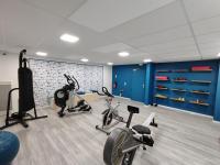 a gym with bikes and exercise equipment in a room at Le Stratège in Marseille