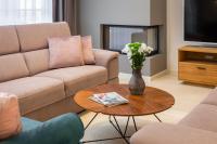ein Wohnzimmer mit einem Sofa und einem Tisch mit Blumen in der Unterkunft Villa Grace by ILC (Istria Luxury Collection) in Brtonigla