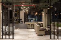 a lobby with chairs and a bar in the background at Eastin Hotel Vientiane in Vientiane