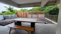 a wooden deck with a bench and a fence at Fu Wan Cafe Villa in Donggang