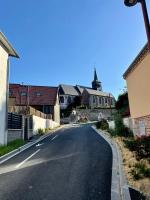 an empty road in a village with a church at L&#39;écureuil de la Baie - maison en Baie de Somme in Mons-Boubert