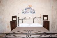 A bed or beds in a room at Dimora Maria Charming Home