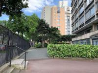 a walkway in a city with tall buildings at Rob’s Place - Paris Convention Center in Vanves