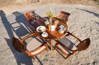 a wooden table with chairs on the beach at Clarks Safari Jawai in Jawāi Bāndh