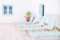 a row of empty chairs in a waiting room at Korali Garden in Naxos Chora