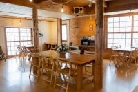 a dining room with a wooden table and chairs at Alpenglow Lodges Ginkei in Niseko
