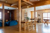 a dining room and living room with a table and chairs at Alpenglow Lodges Ginkei in Niseko