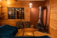 a living room with a fireplace and a couch and a table at Alpenglow Lodges Ginkei in Niseko