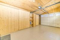 a large garage with wooden walls and a ceiling at Alpes Sweet Home - Chalet La Biche in L&#39;Alpe-d&#39;Huez