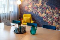 a room with a table with a laptop and a chair at Hotel Sparre in Porvoo