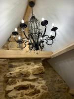 a chandelier hanging from the ceiling in a room at Gîte chez le Gaulois in Carsac-Aillac