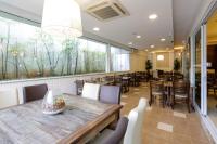 a restaurant with tables and chairs and a large window at Interclass Florianópolis in Florianópolis