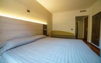 Łóżko lub łóżka w pokoju w obiekcie Hotel Lago Bin