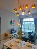 a living room with a table and a blue couch at MLH Designer Suites @ Jesselton Quay CityPads in Kota Kinabalu