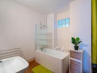 a white bathroom with a tub and a sink at Apartment Men Er Bellec-1 by Interhome in Saint-Philibert